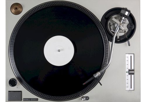 A turntable with a vinyl record on it, featuring a tonearm, needle, and speed control slider on the right.